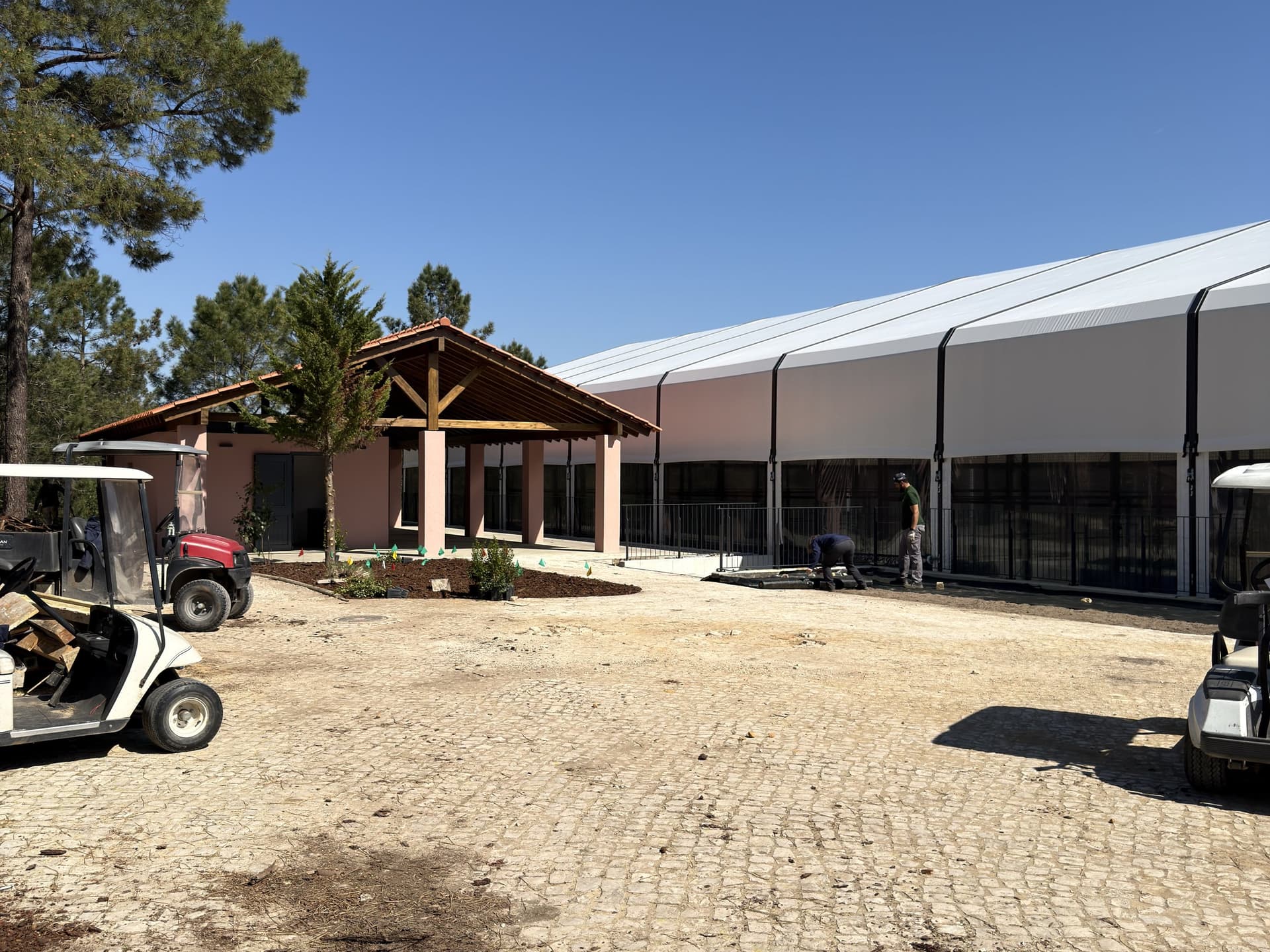 Peru Padel club exterior — courts building with golf buggy on cobblestone driveway
